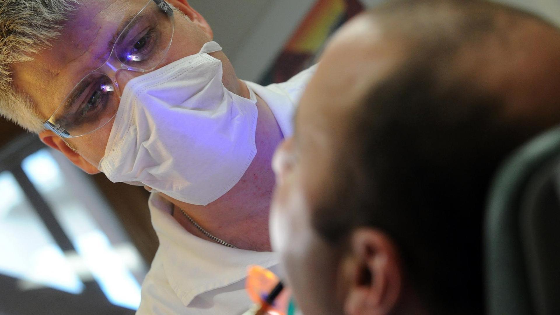 A patient gets dental treatment at a local health center in Budapest, on November 27, 2012. Every year some 80,000 patients from Western Europe travel to Hungary to pay a visit to the dentist. Hungary has in fact for many years been the leading destination in Europe for dental tourism, a phenomen which has brought benefits across the economy. AFP PHOTO / ATTILA KISBENEDEK / AFP PHOTO / ATTILA KISBENEDEK