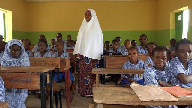 Eine junge muslimische Lehrerin steht am Dienstag (20.09.2005) in einer Schule in den Bergen nördlich von Abuja, der Hauptstadt des westafrikanischen Staates Nigeria, im Klassenzimmer zwischen ihren Schülern.