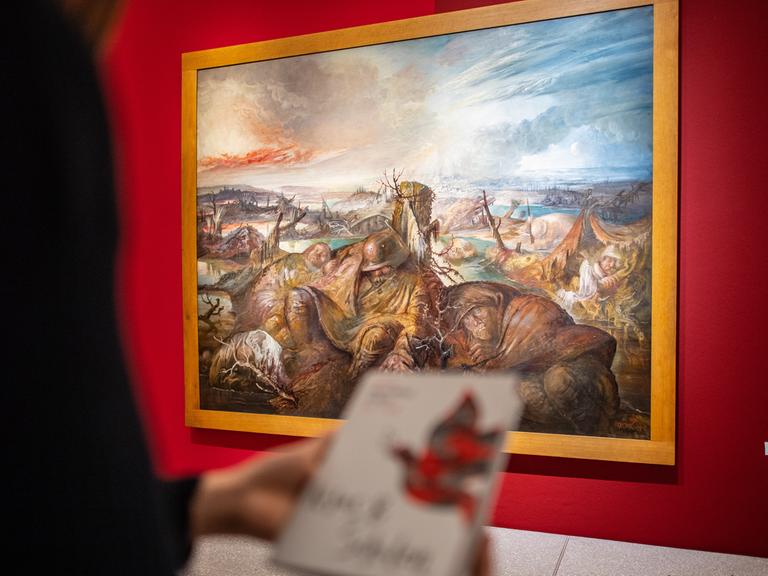 Eine Besucherin steht im LWL Museum für Kunst und Kultur zum Thema: "Frieden, von der Antike bis heute" an dem Schlachtfeldpanorama von Otto Dix.