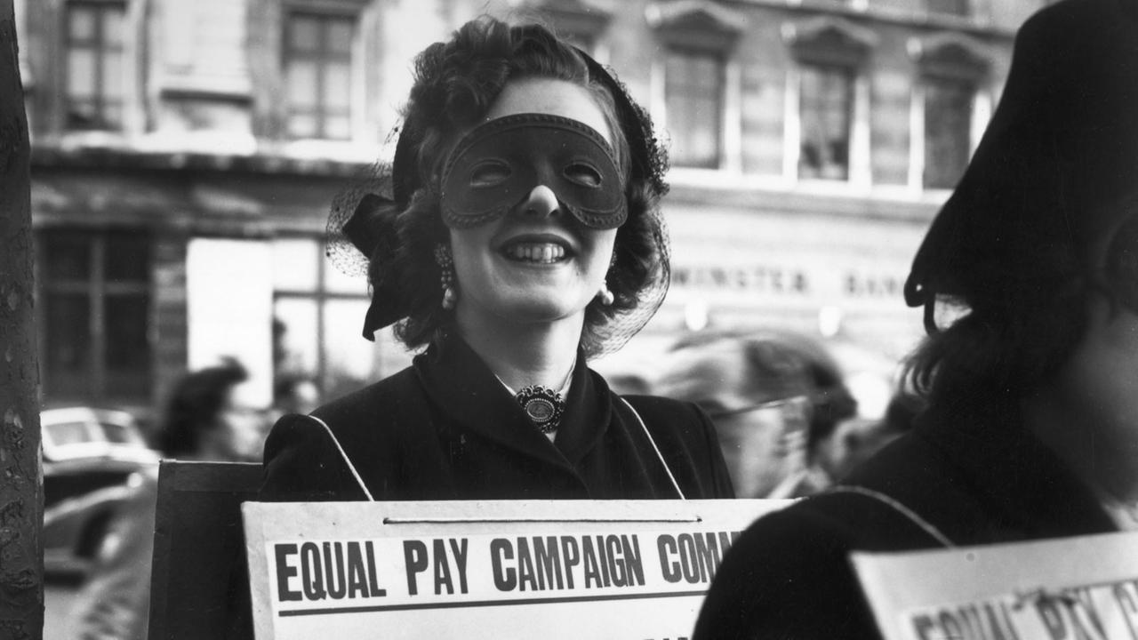 7th May 1952: Sonia Banular wears a mask to a poster parade in London demanding equal pay for women. (Photo by Keystone/Getty Images) 7th May 1952: Sonia Banular wears a mask to a poster parade in London demanding equal pay for women. (Photo by Keystone/Getty Images)