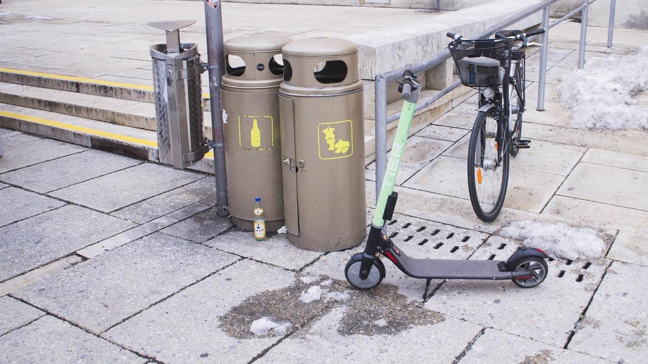 Ein Elektroroller steht vor einem Mülleimer in der Innenstadt von Wien. Ein Elektroroller steht vor einem Mülleimer in der Innenstadt von Wien.