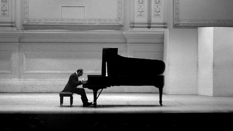 Schwarz-Weiß-Fotografie von 19. Mai 1965, aufgenommen in der New Yorker Carnegie Hall. Der Pianist Vladimir Horowitz spielt auf einem Flügel, er trägt einen Konzert-Frack