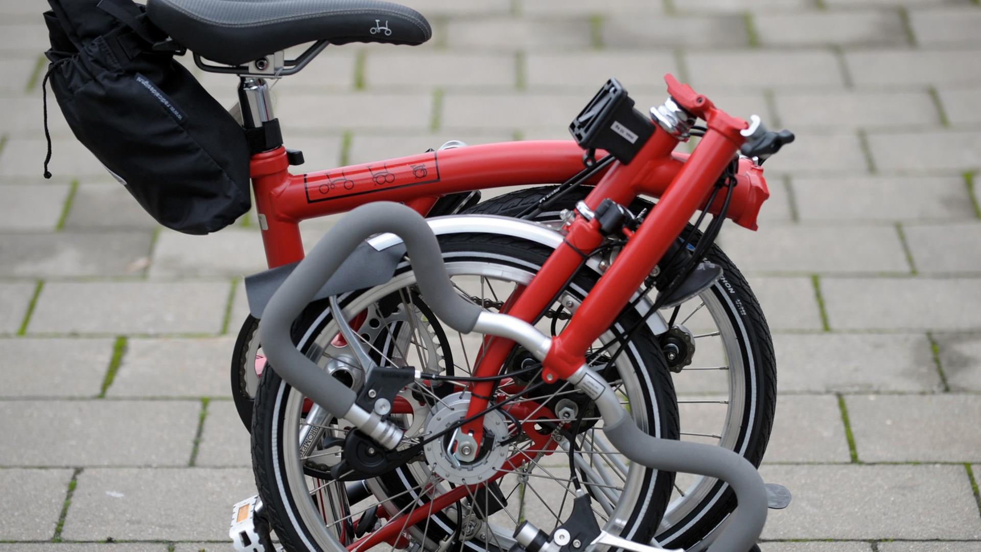 Ein zusammengeklapptes Faltrad (Hersteller: Brompton) auf der Fahrradmesse "abgefahren" in Leipzig. Ein zusammengeklapptes Faltrad (Hersteller: Brompton) auf der Fahrradmesse "abgefahren" in Leipzig.