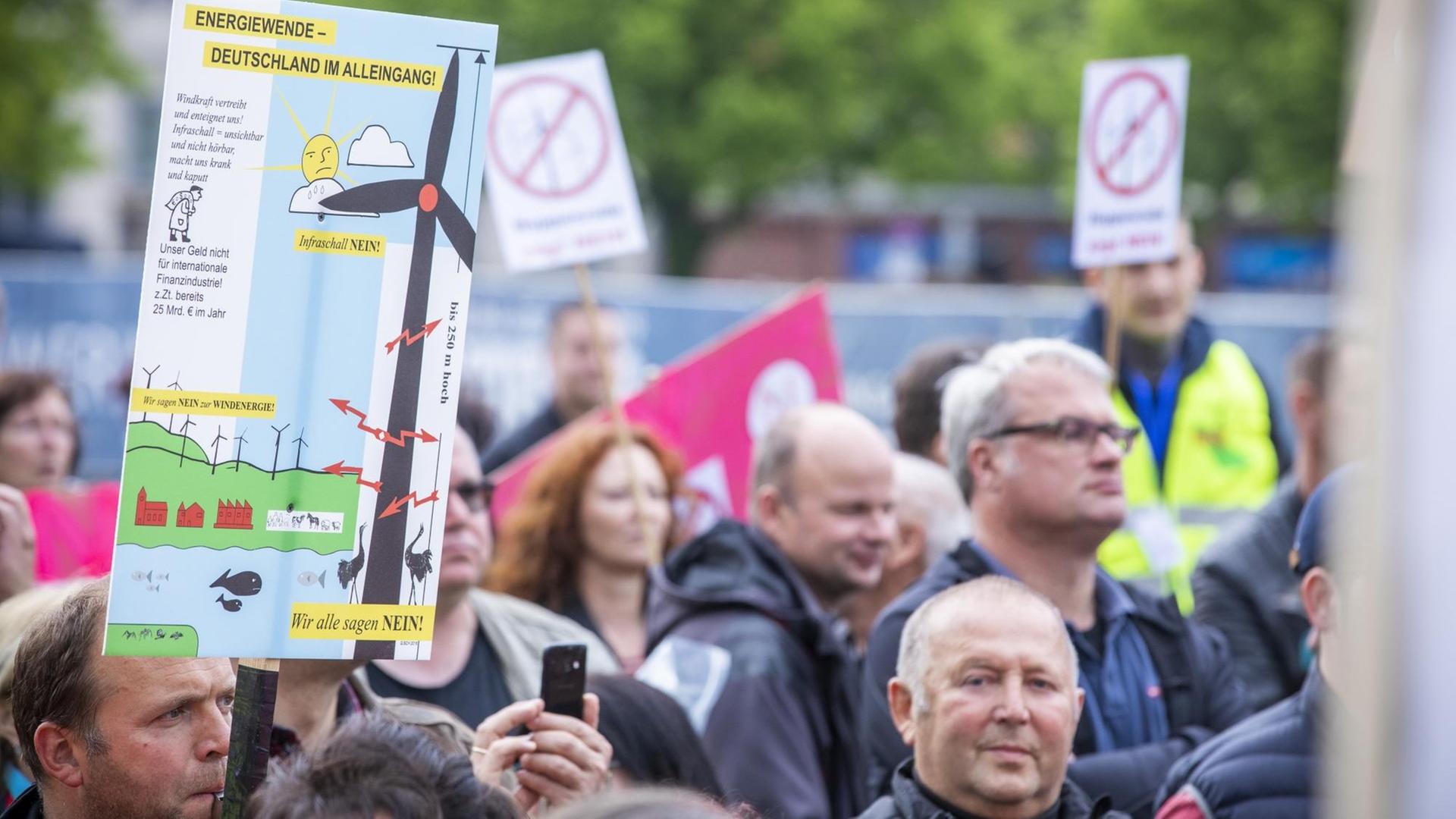 Demonstranten tragen Protestschilder gegen den Bau zusätzlicher Windkraftanlagen. Demonstranten tragen Protestschilder gegen den Bau zusätzlicher Windkraftanlagen.