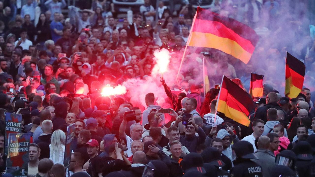Chemnitz am 27. August 2018: Demonstranten der rechten Szene zünden Pyrotechnik und schwenken Deutschlandfahnen. Chemnitz am 27. August 2018: Demonstranten der rechten Szene zünden Pyrotechnik und schwenken Deutschlandfahnen.
