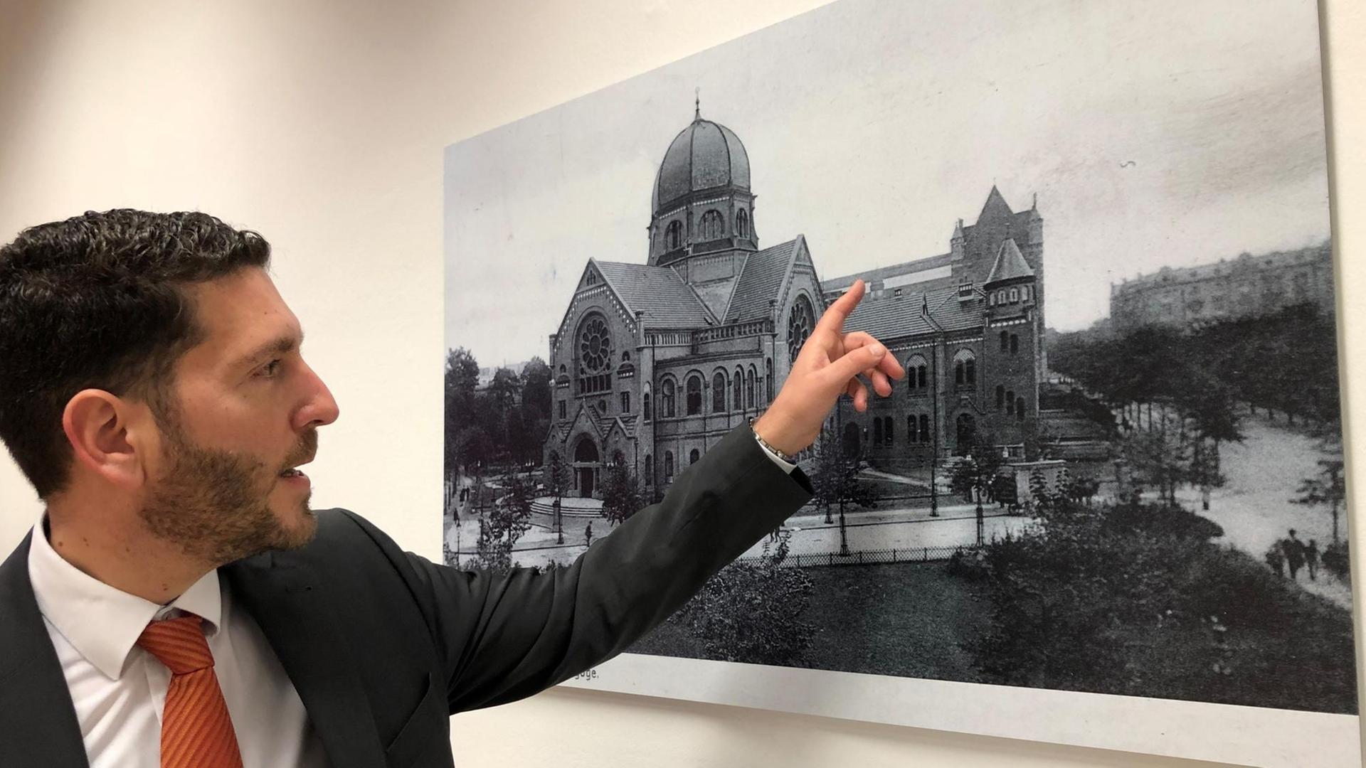 Philipp Stricharz, 1. Vorsitzender der Jüdischen Gemeinde Hamburg, zeigt auf ein historisches Foto der Bornplatzsynagoge. Philipp Stricharz, 1. Vorsitzender der Jüdischen Gemeinde Hamburg, zeigt auf ein historisches Foto der Bornplatzsynagoge.