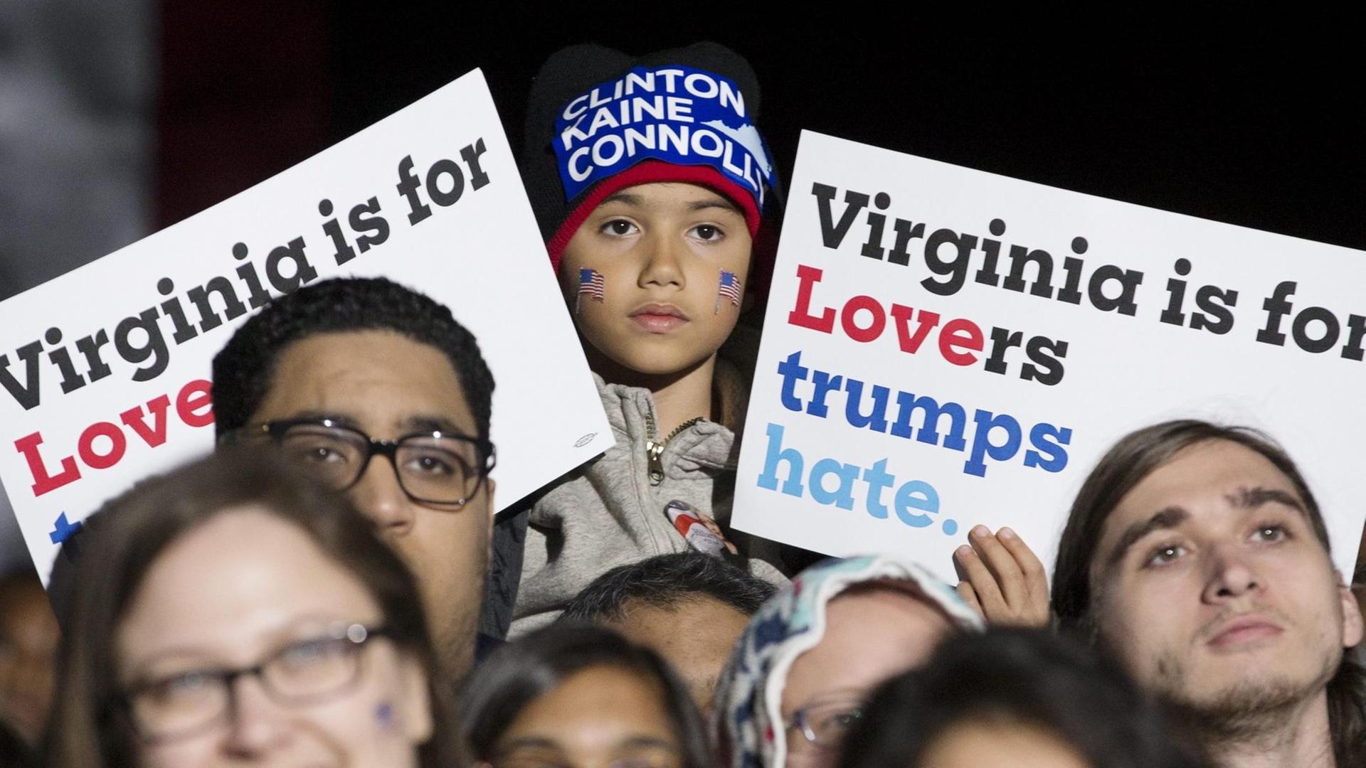 Ein Kind hält ein Schild in die Höhe, das für Clinton wirbt. Ein Kind hält ein Schild in die Höhe, das für Clinton wirbt.