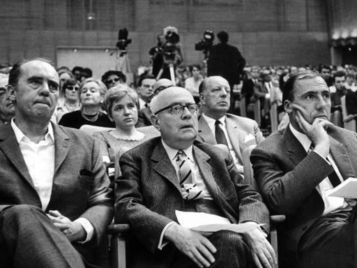 (L-r) Der Schriftsteller Heinrich Böll, der Soziologie-Professor Theodor Adorno und der Verleger Siegfried Unseld hören am 28.5.1968 bei einer Veranstaltung gegen die Notstandsgesetzgebung im Großen Sendesaal des Hessischen Rundfunks in Frankfurt am Main einem Vortrag zu.