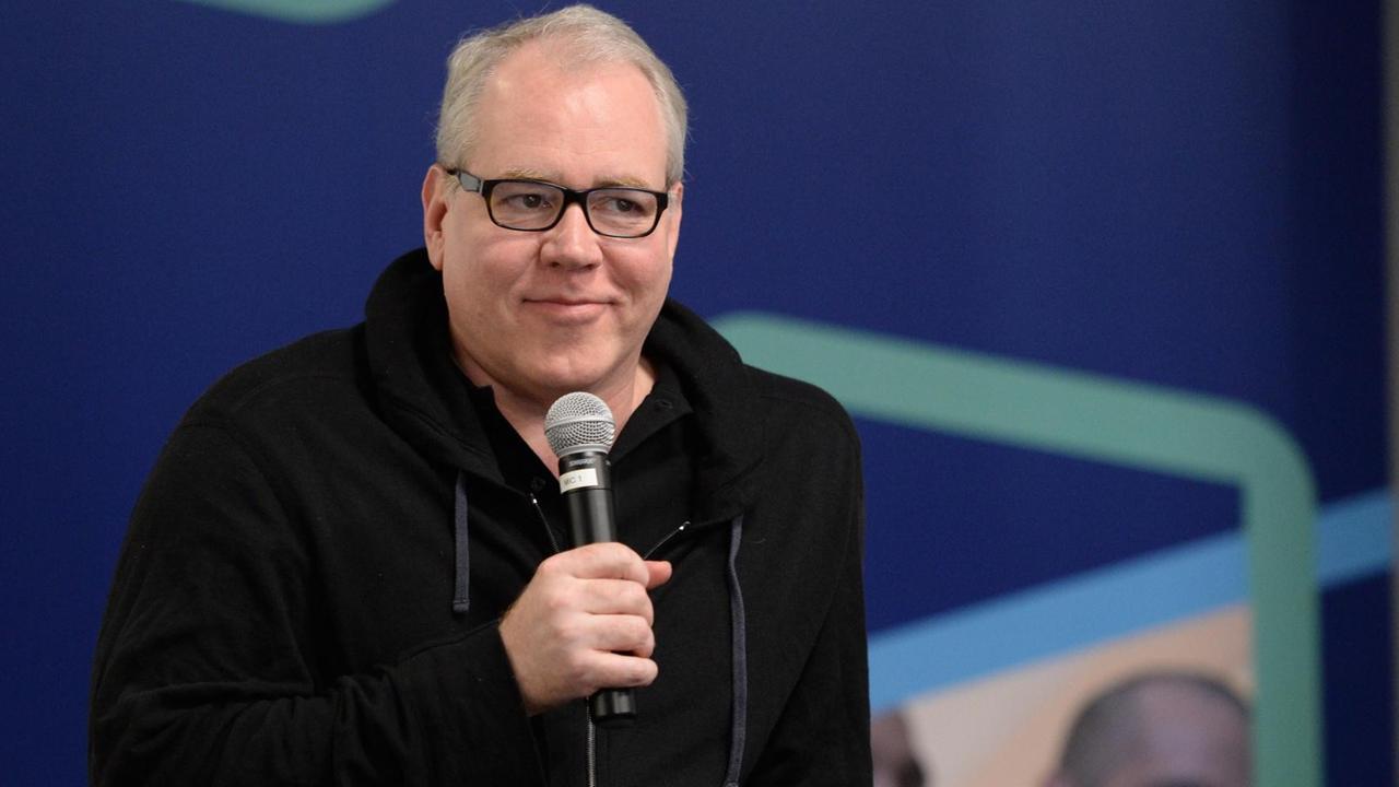 Autor Bret Easton Ellis sitzt auf einem Podium, hat ein Mikrofon in der Hand und guckt leicht lächelnd ins Publikum. Autor Bret Easton Ellis sitzt auf einem Podium, hat ein Mikrofon in der Hand und guckt leicht lächelnd ins Publikum.
