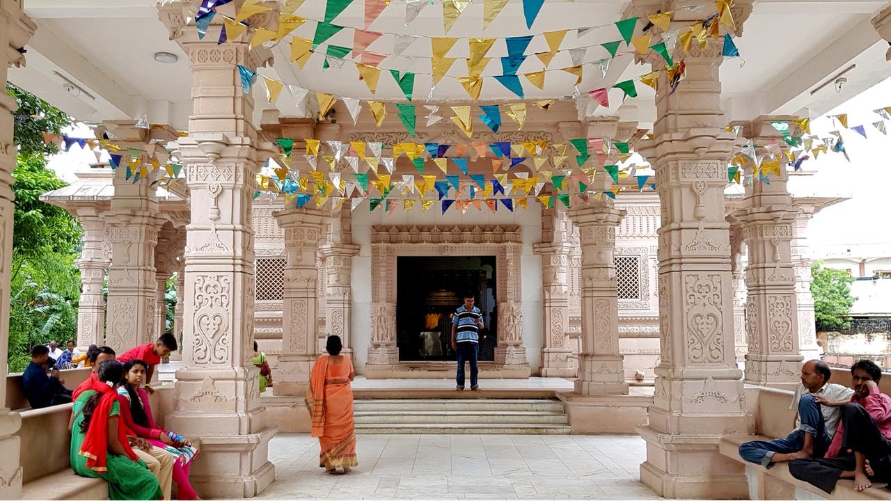 Ein Säulengang des Bhalka-Tirtha-Tempels im Westen Indiens ist mit blau-gelben Wimpeln geschmückt. Ein Säulengang des Bhalka-Tirtha-Tempels im Westen Indiens ist mit blau-gelben Wimpeln geschmückt.