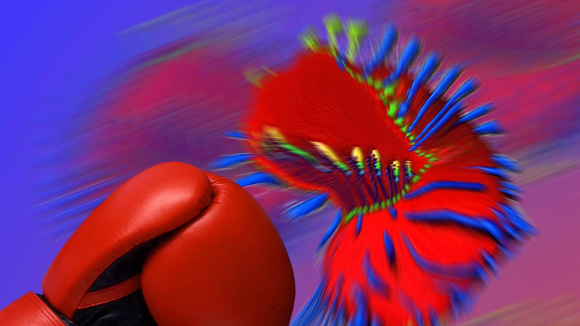 Ein Boxhandschuh wehrt den Angriff eines Virus ab. Ein Boxhandschuh wehrt den Angriff eines Virus ab.