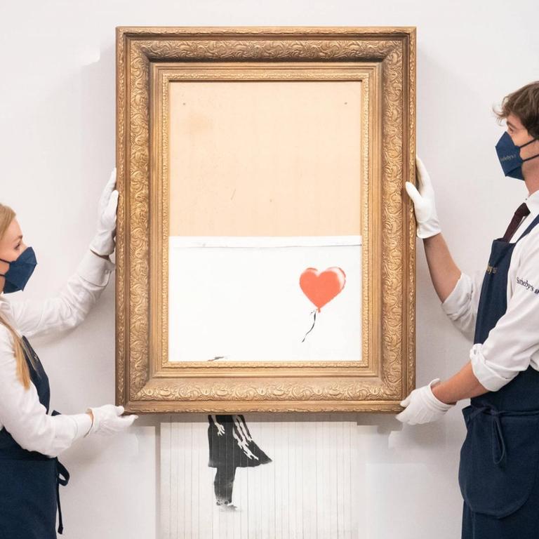October 14, 2021, London, UK: File photo dated 03/09/21 of art handlers at Sotheby s auction house with Banksy s Love is in the Bin , which self-shredded immediately after it was sold at auction for 1,042,000, before it returns to auction this evening at Sotheby s, London, with an estimate to fetch between 4 to 6 million. Issue date: Thursday October 14, 2021. London UK PUBLICATIONxINxGERxSUIxAUTxONLY - ZUMAp134 20211014_zba_p134_156 Copyright: xDominicxLipinskix