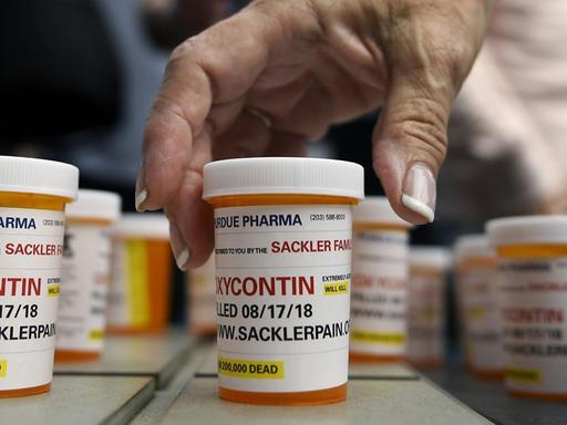 FILE - In this Aug. 17, 2018 file photo, family and friends who have lost loved ones to OxyContin and opioid overdoses leave pill bottles in protest outside the headquarters of Purdue Pharma, which is owned by the Sackler family, in Stamford, Conn. New York is suing the billionaire family behind Oxycontin, alleging the drugmaker fueled the opioid crisis by putting hunger for profits over patient safety. (AP Photo/Jessica Hill, File) |