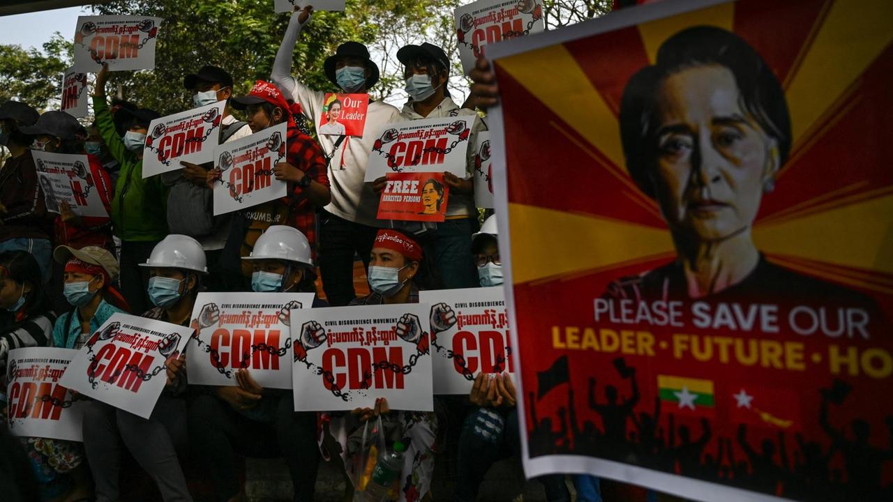 Demonstranten halten Schilder am 14. Februar Schilderhoch, die die Civil Disobedience Movement (CDM) unterstützen, und eines, das die Freilassung von Regierungschefin Aung San Suu Kyi fordert.