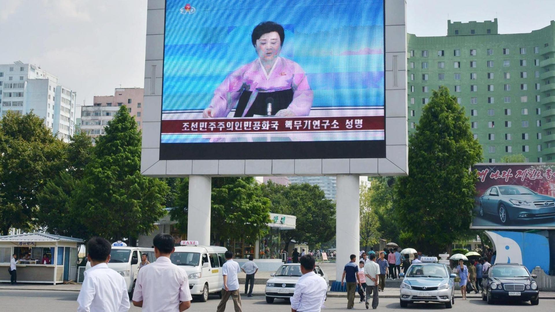 Eine Sprecherin des staatlichen Fernsehens in Nordkorea berichtet über den fünften Atom-Test des Landes. Sie ist auf einem großen Bildschirm vor der Pjöngjang Station zu sehen. Eine Sprecherin des staatlichen Fernsehens in Nordkorea berichtet über den fünften Atom-Test des Landes. Sie ist auf einem großen Bildschirm vor der Pjöngjang Station zu sehen.