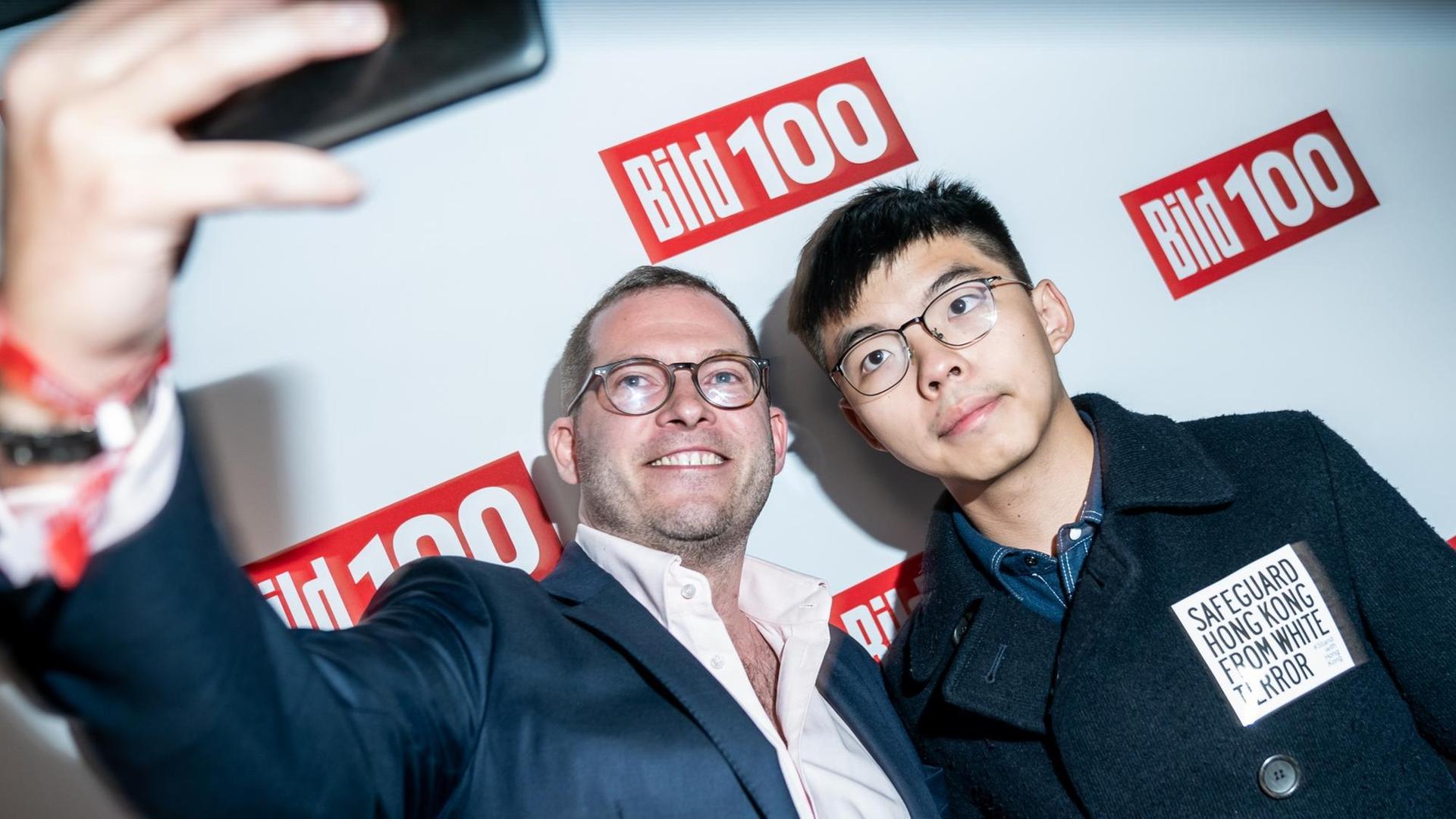 "Bild"-Chefredakteur Julian Reichelt macht ein Selfie mit Joshua Wong, Demokratie-Aktivist der Proteste in Hongkong, bei dessen Eintreffen zur Bild100-Party mit Persönlichkeiten aus Politik, Gesellschaft und Sport. "Bild"-Chefredakteur Julian Reichelt macht ein Selfie mit Joshua Wong, Demokratie-Aktivist der Proteste in Hongkong, bei dessen Eintreffen zur Bild100-Party mit Persönlichkeiten aus Politik, Gesellschaft und Sport.