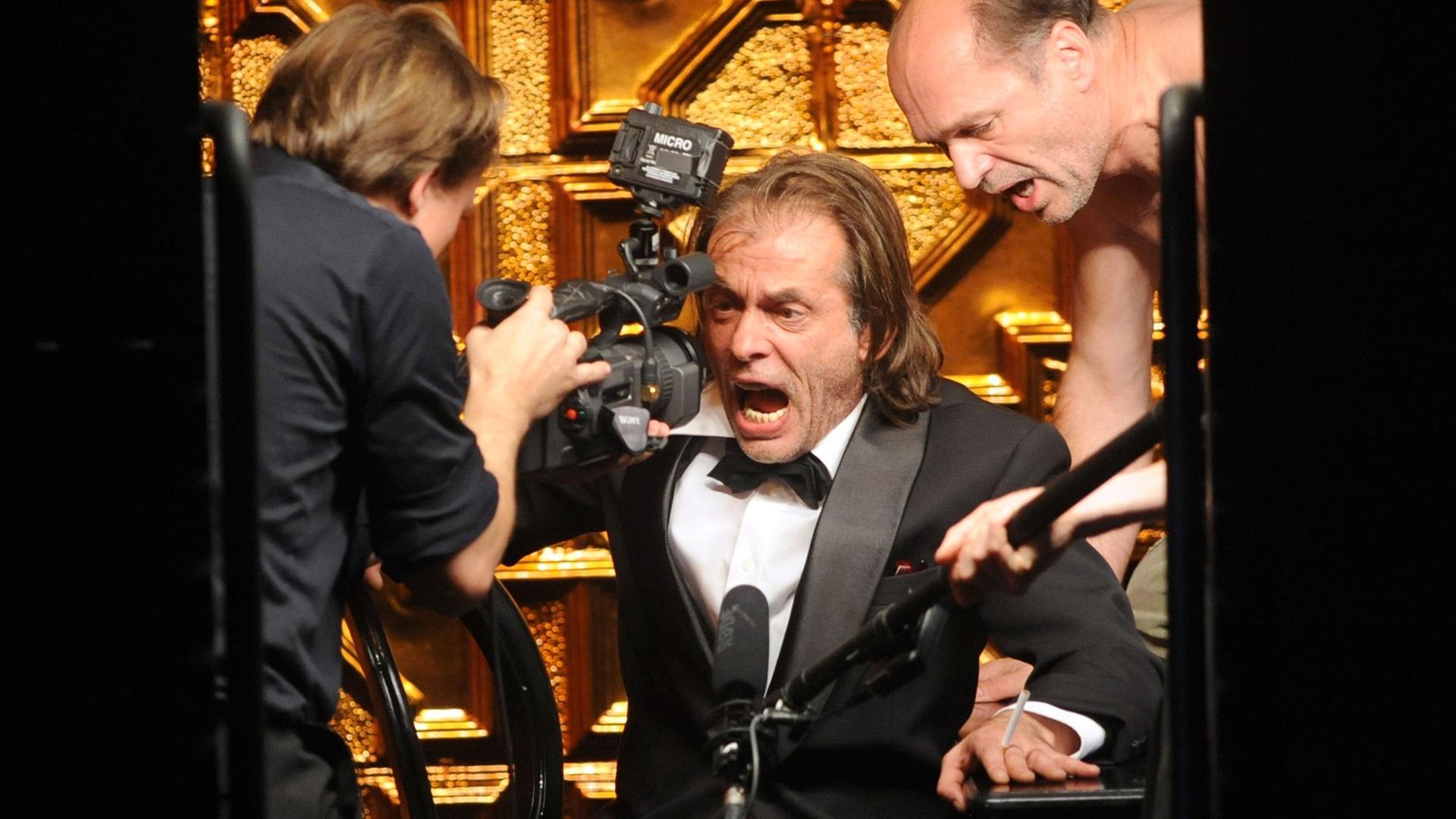 Die Schauspieler Mex Schlüpfer (M) als Franco Vegliani und Horst Günter Marx (r) als Graf Augstein de Foxa im Stück "Kaputt" an der Berliner Volksbühne. Die Schauspieler Mex Schlüpfer (M) als Franco Vegliani und Horst Günter Marx (r) als Graf Augstein de Foxa im Stück "Kaputt" an der Berliner Volksbühne.
