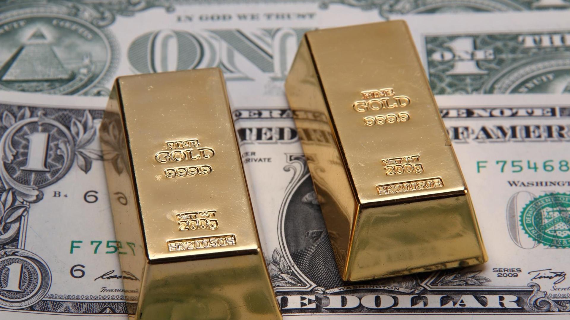 Zwei 200 Gramm schwere Goldbarren vor Dollarnoten | Verwendung weltweit Zwei 200 Gramm schwere Goldbarren vor Dollarnoten | Verwendung weltweit