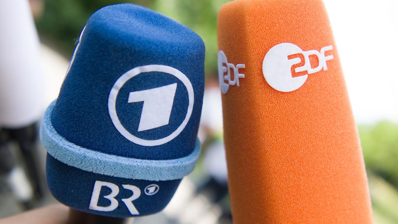 Fernsehmikrofone mit den Logos von ARD und ZDF stehen vor Beginn einer Pressekonferenz nebeneinander