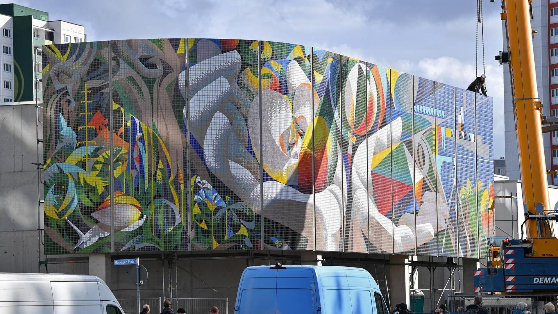 29.10.2019, Thüringen, Erfurt: Ein Element vom Wandmosaik "Die Beziehung des Menschen zu Natur und Technik" (1980-1984) des Spaniers Josep Renau (1907-1982) wird montiert. Nach vierjähriger Planungs- und Restaurierungszeit kehrt das Großmosaik wieder zurück. Das Wandbild konnte 2012 noch vor dem Abriss des Kultur- und Freizeitzentrums am Moskauer Platz vor der Zerstörung bewahrt werden, wurde fachgerecht abgenommen und bis zu seiner Restaurierung in Containern eingelagert. Foto: Martin Schutt/dpa-Zentralbild/dpa | Verwendung weltweit 29.10.2019, Thüringen, Erfurt: Ein Element vom Wandmosaik "Die Beziehung des Menschen zu Natur und Technik" (1980-1984) des Spaniers Josep Renau (1907-1982) wird montiert. Nach vierjähriger Planungs- und Restaurierungszeit kehrt das Großmosaik wieder zurück. Das Wandbild konnte 2012 noch vor dem Abriss des Kultur- und Freizeitzentrums am Moskauer Platz vor der Zerstörung bewahrt werden, wurde fachgerecht abgenommen und bis zu seiner Restaurierung in Containern eingelagert. Foto: Martin Schutt/dpa-Zentralbild/dpa | Verwendung weltweit