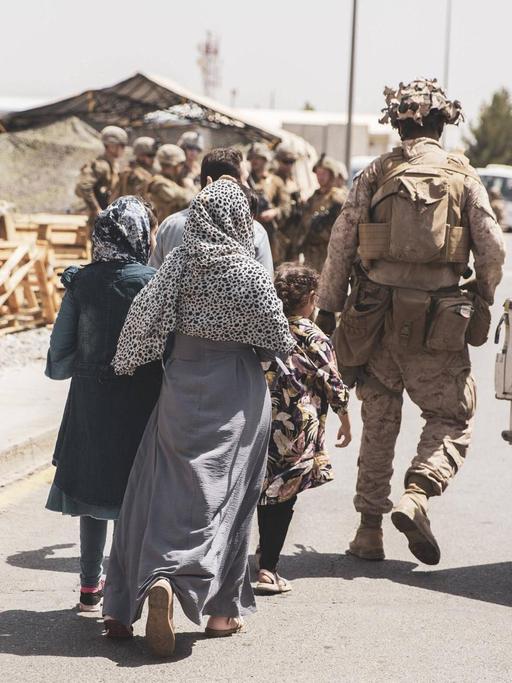 US-Soldaten begleiten eine afghanische Familie am Flughafen Kabul.