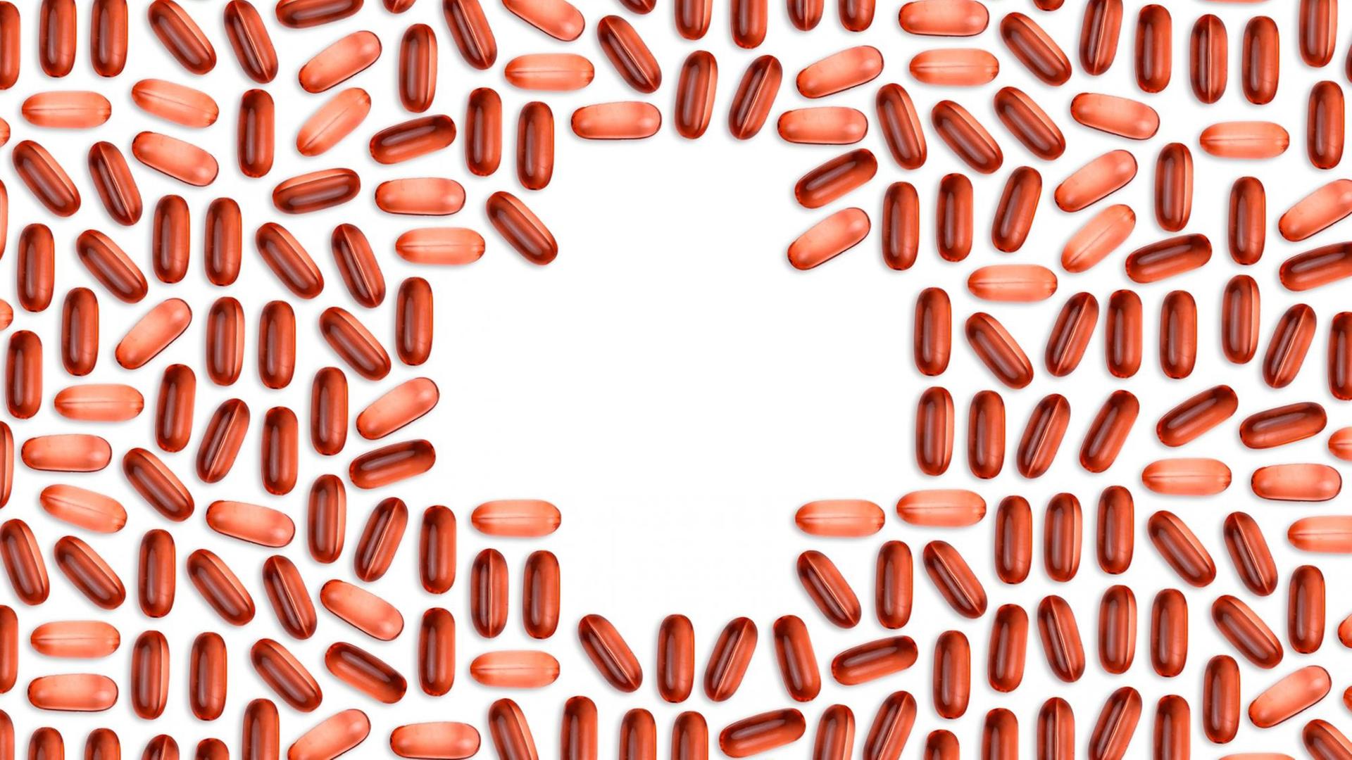 Rötliche Pillen bilden in der Mitte des Bildes ein Apothekenkreuz.