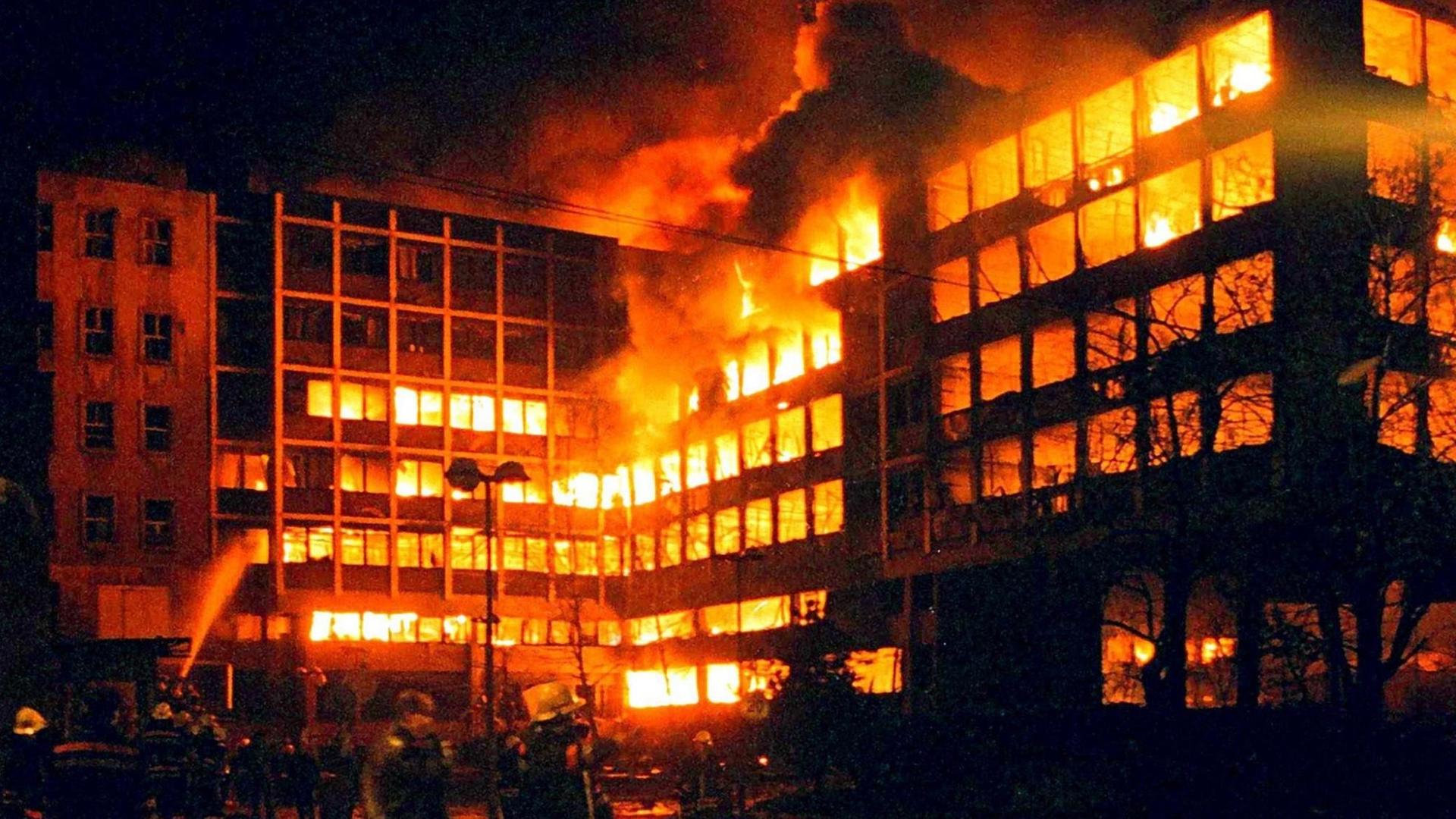 Belgrader Feuerwehrleute am 3.4.1999 vor dem brennenden serbischen Innenministerium in Belgrad. Mehrere Marschflugkörper schlugen gegen 1.00 Uhr morgens in den benachbarten Gebäude des serbischen und des jugoslawischen Innenministeriums ein. Augenzeugen berichteten von fünf gewaltigen Explosionen im dichtbesiedelten Stadtteil um die verkehrswichtige Knez-Milosa-Straße. Die Fensterscheiben der umliegenden Wohnhäuser seien zerborsten. Die beiden getroffenen Ministerien liegen unmittelbar neben einem großen Krankenhauskomplex. Die Nato hatte erstmals seit Beginn der Offensive vor zehn Tagen das Zentrum Belgrads beschossen.