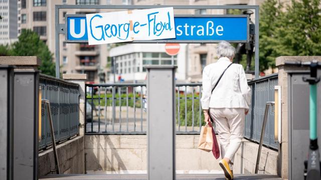 An der U-Bahnhaltestelle Mohrenstraße in Berlin-Mitte hängt auf dem U-Bahn-Halstestellenschild ein Plakat mit der Aufschrift "George-Floyd".