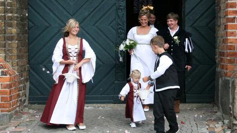 Das Brautpaar einer historischen Kaufmannshochzeit tritt aus der historischen Kirche in Anklam heraus. Seit 1283 ist Anklam mit Lübischem Recht Hansestadt.