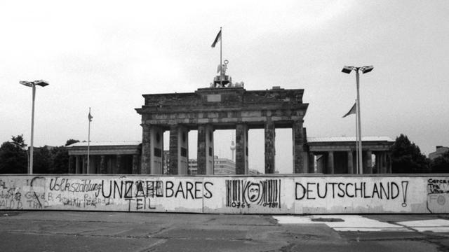 Historisches Foto von 1987: An der Mauer vor dem Brandenburger Tor in Berlin ein Graffiti "Unzählbares Deutschland".