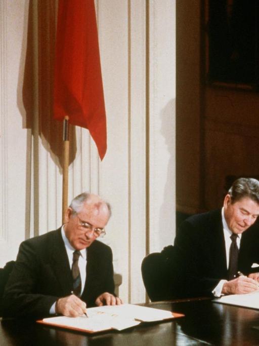 US-Präsident Ronald Reagan (r) und der sowjetische Parteichef Michail Gorbatschow unterzeichnen am 08.12.87 in Washington den INF-Vertrag zur Vernichtung der atomaren Mittelstreckenraketen (Archivfoto). Reagan ist nach langem Kampf gegen seine Alzheimer-Erkrankung im Alter von 93 Jahren gestorben. Reagan, der von 1981 bis 1989 als 40. Präsident im Weißen Haus amtierte, starb am Samstag (05.06.2004) um 13.09 Uhr Ortszeit (22.09 Uhr MESZ) im Kreis seiner engsten Familienangehörigen in Bel Air in Kalifornien.