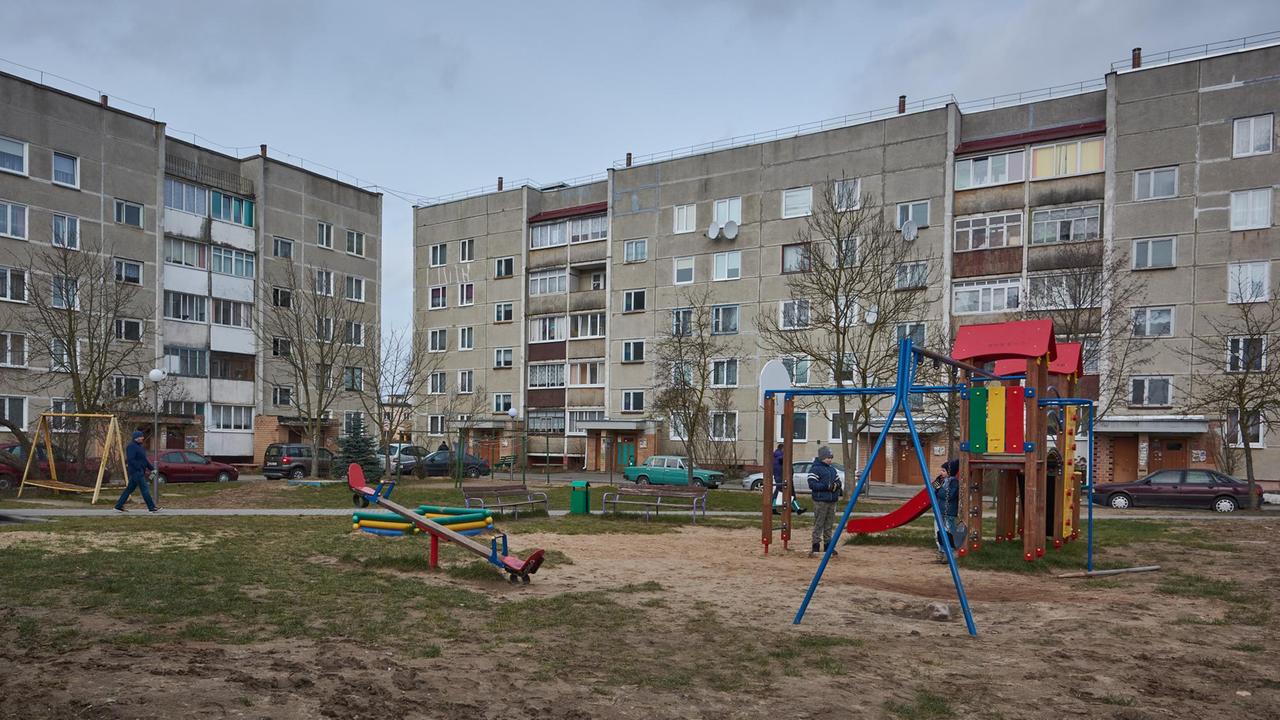 In den "Tschernobyl-Häusern" von Astravets wohnen seit Ende der 80er Jahre etwa 100 Familien, die aus dem Katastrophengebiet um das AKW Tschernobyl geflüchtet sind. Graue Wohnblöcke und davor ein Kinderspielplatz.