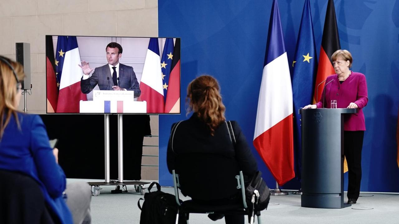 Macron und Merkel bei einer gemeinsamen Video-Pressekonferenz zu den Folgen des Coronavirus. Macron und Merkel bei einer gemeinsamen Video-Pressekonferenz zu den Folgen des Coronavirus.