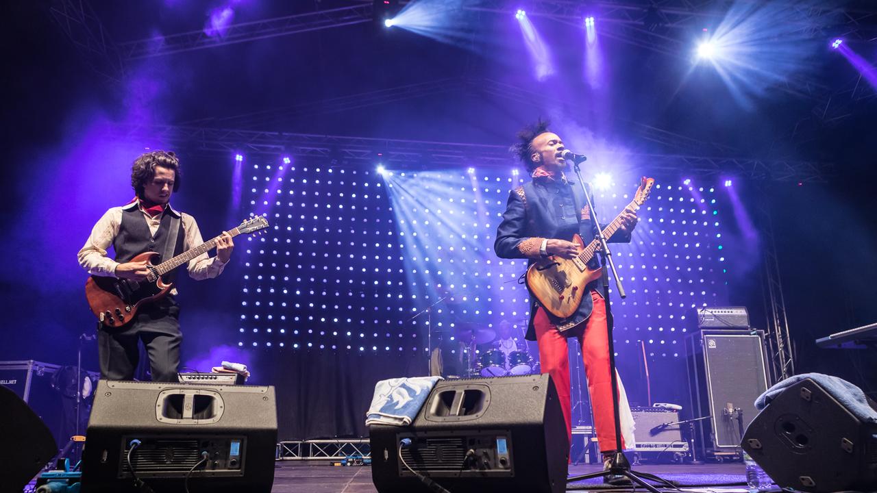 Fantastic Negrito und ein Mann mit Gitarre stehen auf der Bühne des Blues Festivals Schöppingen 2019. Fantastic Negrito und ein Mann mit Gitarre stehen auf der Bühne des Blues Festivals Schöppingen 2019.