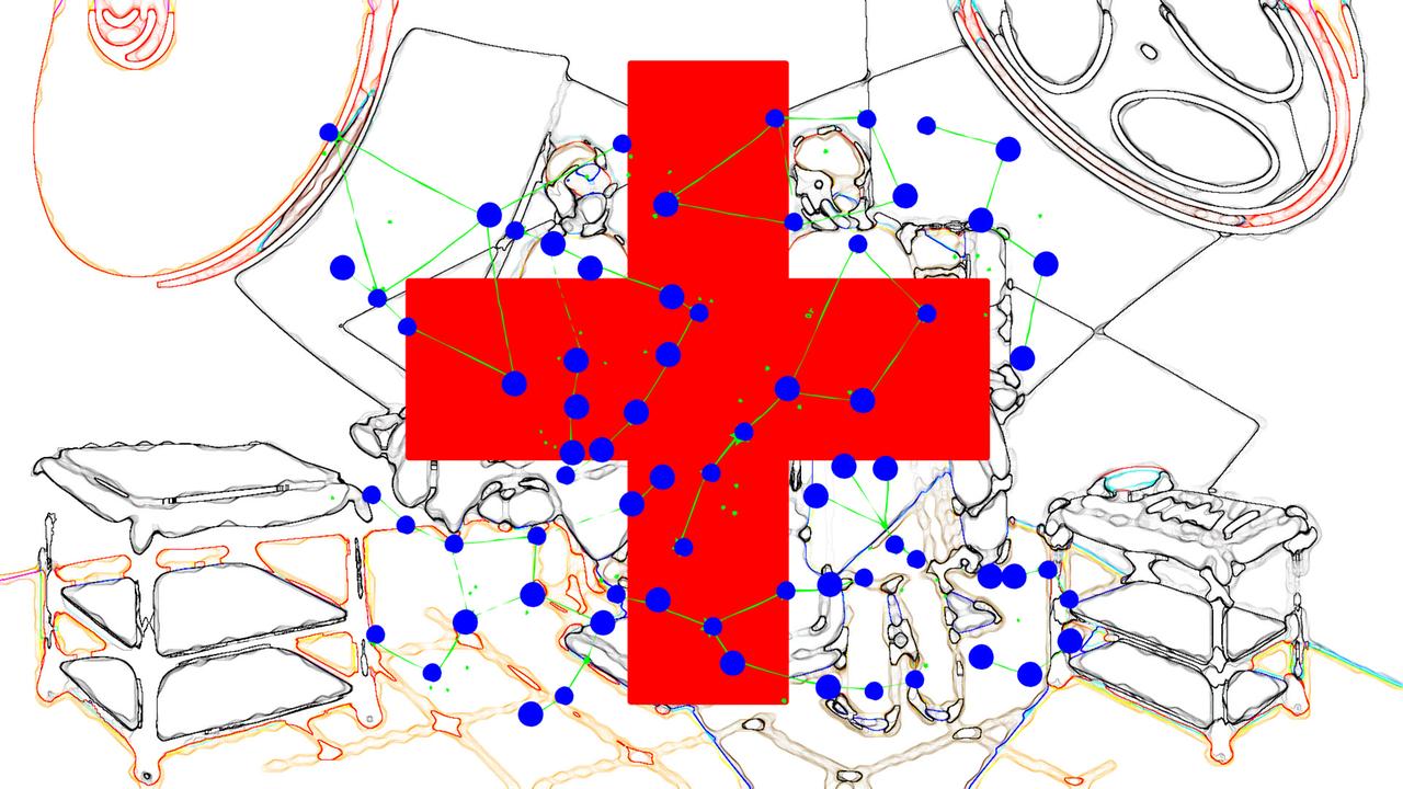 Ein rotes Kreuz und viele kleine blaue Punkte sind auf einer Grafik zu sehen. Im Hintergrund schemenhaft die Einrichtung eines Krankenhauszimmers. Ein rotes Kreuz und viele kleine blaue Punkte sind auf einer Grafik zu sehen. Im Hintergrund schemenhaft die Einrichtung eines Krankenhauszimmers.