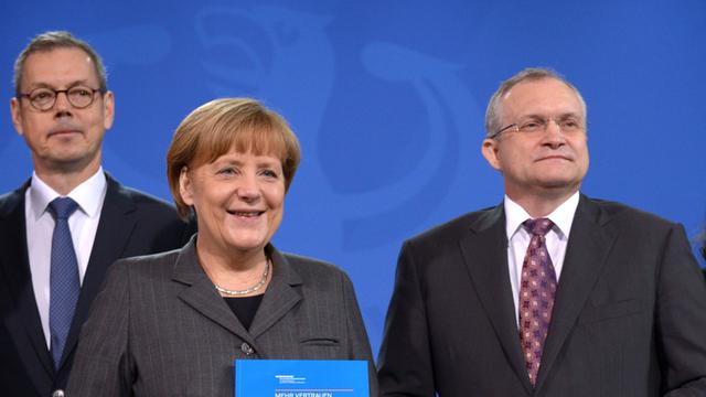 Bundeskanzlerin Angela Merkel erhält den Jahresbericht der Wirtschaftsweisen, hier mit den Professoren Peter Bofinger (l.) und Christoph Schmidt.
