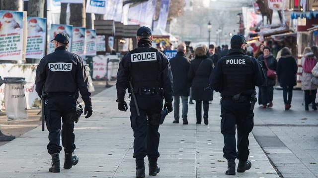 Französische Polizisten bewachen den Weihnachtsmarkt auf dem Champs-Elysees in Paris. Nach dem Anschlag in Berlin wurden auch in Frankreich die Sicherheitsmaßnahmen verschärft.