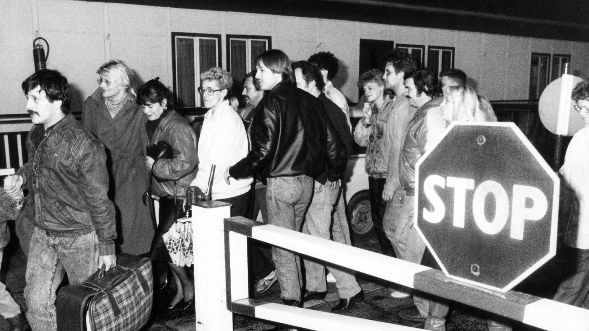 In der Nacht vom 9. auf den 10. November passieren diese Ost-Berliner vor Ihrer Einreise nach West-Berlin ein Grenzhäuschen. Nach der Bekanntgabe einer neuen großzügigen Reiseregelung für DDR-Bürger auf einer Pressekonferenz der DDR-Regierung am 09.11.1989 in Ost-Berlin fiel die innerdeutsche Grenze. In der Nacht vom 9. auf den 10. November passieren diese Ost-Berliner vor Ihrer Einreise nach West-Berlin ein Grenzhäuschen. Nach der Bekanntgabe einer neuen großzügigen Reiseregelung für DDR-Bürger auf einer Pressekonferenz der DDR-Regierung am 09.11.1989 in Ost-Berlin fiel die innerdeutsche Grenze.
