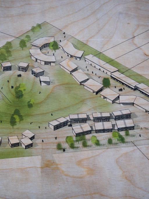 Gezeichneter Entwurf eines Dorfes auf einem Holzbrett