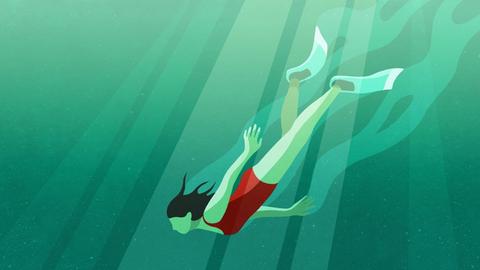 Eine Frau taucht unter Wasser.