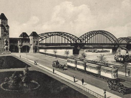 Köln am Rhein, Blick auf die Südbrücke mit Straßenbahn und Rhein (Illustration nach einem Foto, vermutlich um 1915)