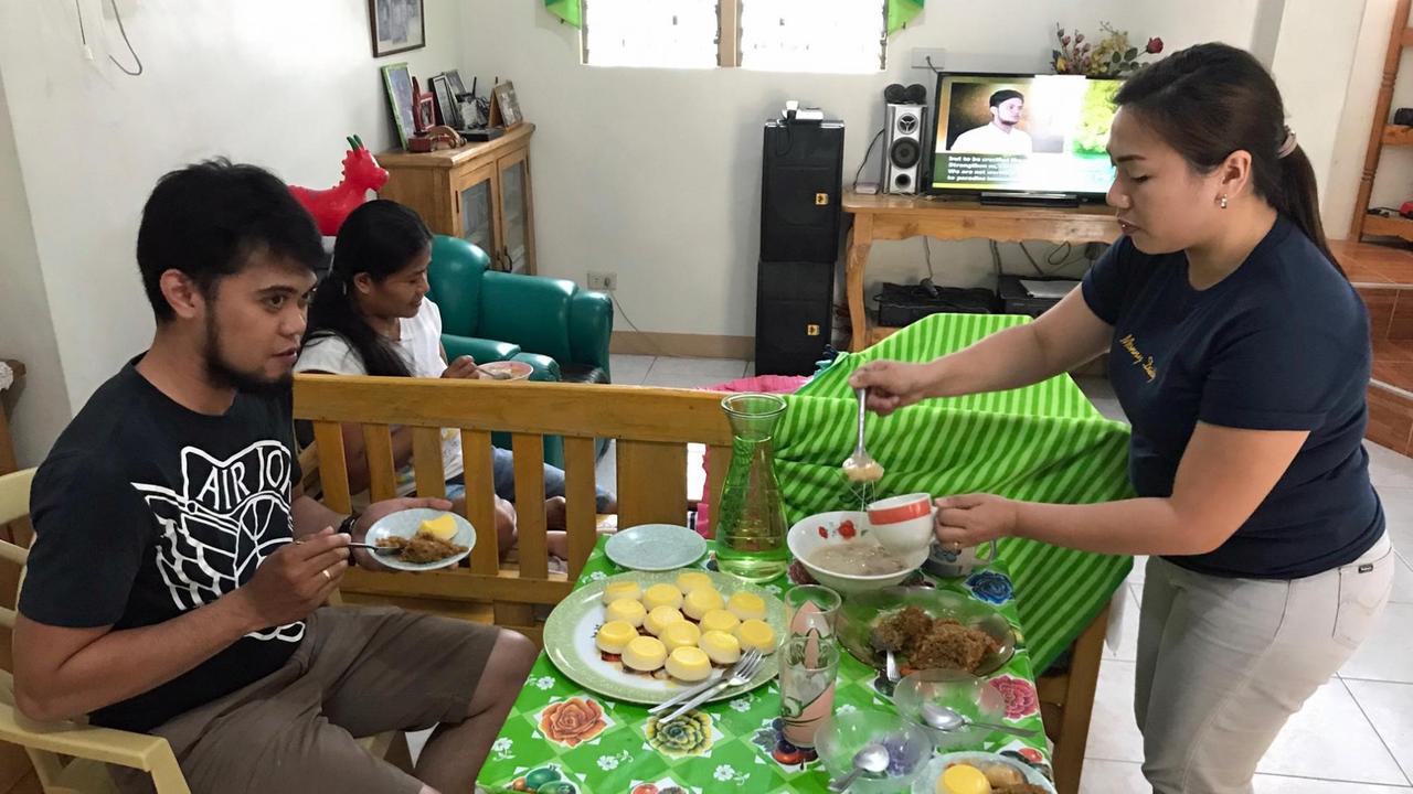 Daisy Agravante mit ihrem Mann zu Hause auf den Philippinen beim Essen