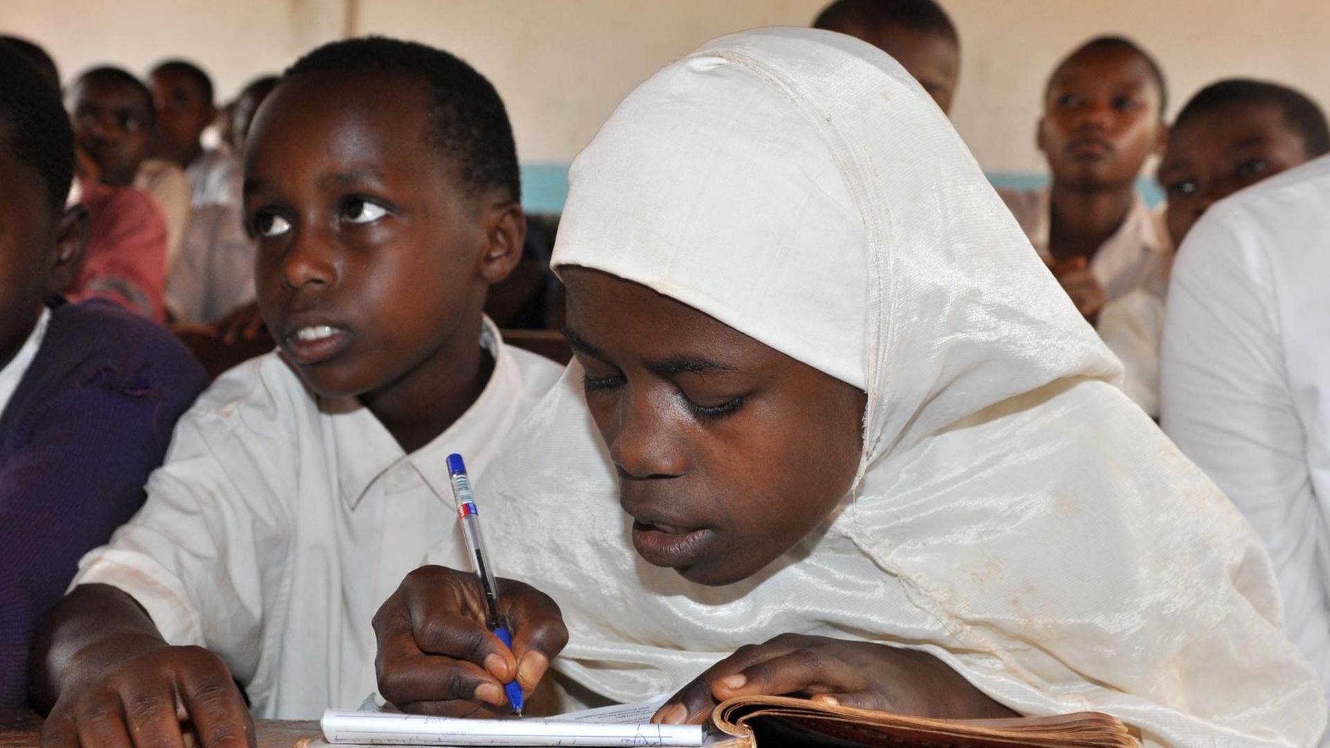 Ein Mädchen lernt in der "Makaburini Primary School" Nähe Korogwe Schreiben. Ein Mädchen lernt in der "Makaburini Primary School" Nähe Korogwe Schreiben.