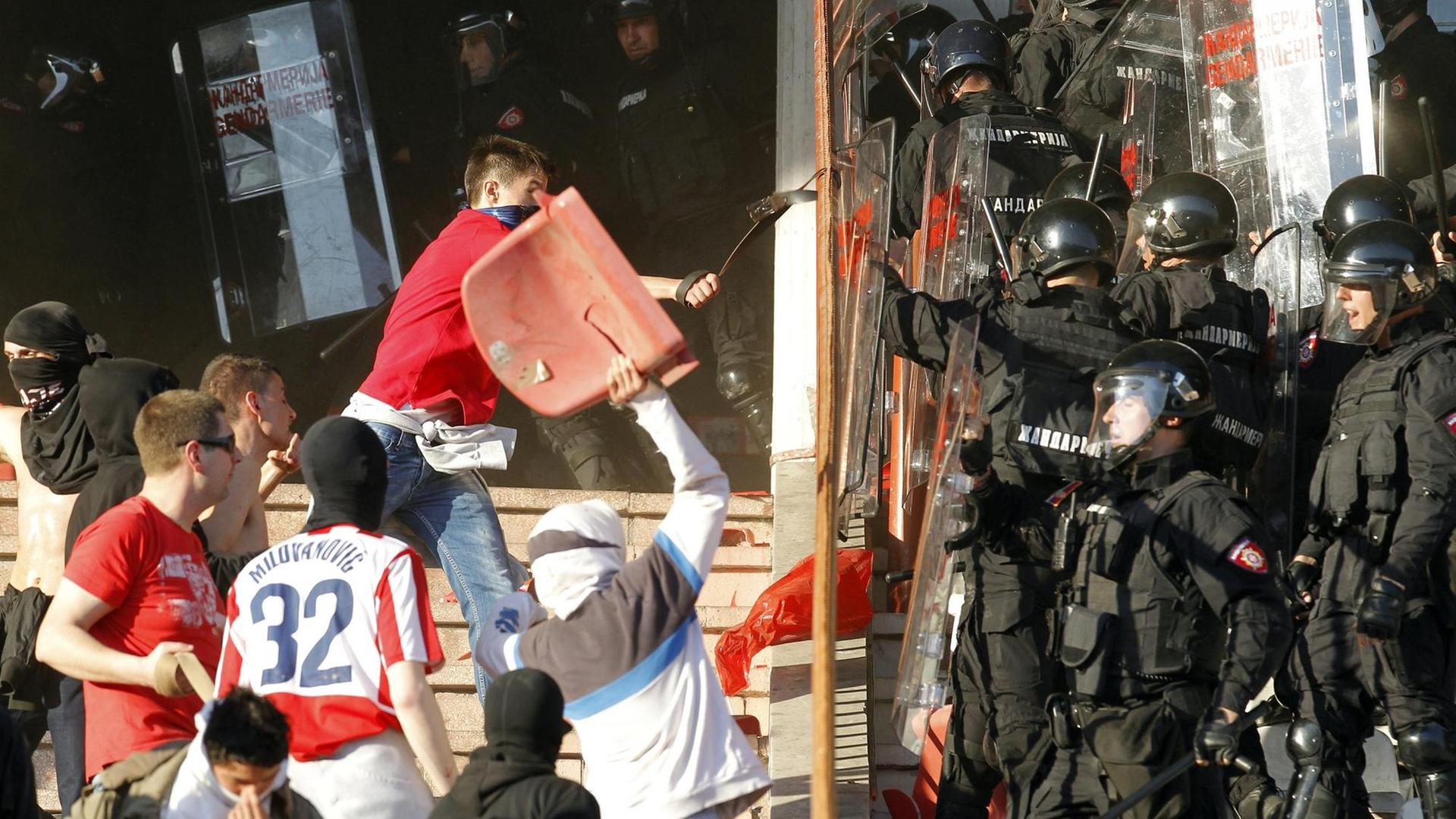 Serbische Polizisten stoßen mit Fans von Roter Stern Belgrad beim Derby gegen Partizan Belgrad im April 2015. Serbische Polizisten stoßen mit Fans von Roter Stern Belgrad beim Derby gegen Partizan Belgrad im April 2015.