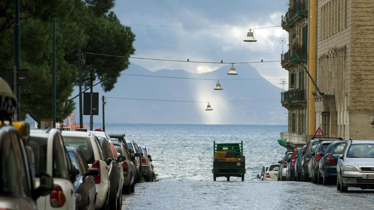Die Altstadt von Neapel (Napoli) in Italien mit Blick über das Meer auf den Vesuv bei Regenwetter.