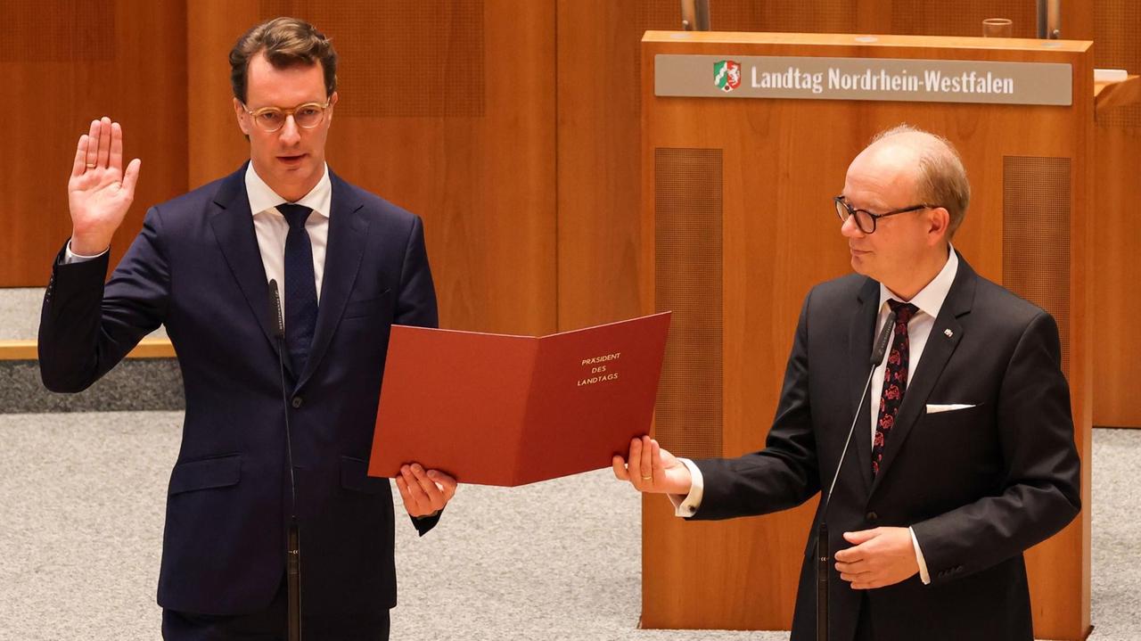 Nordrhein-Westfalen, Düsseldorf: Hendrik Wüst (l, CDU), neuer Ministerpräsident von Nordrhein-Westfalen, leistet den Amtseid neben André Kuper (CDU), Landtagspräsident. Nordrhein-Westfalen, Düsseldorf: Hendrik Wüst (l, CDU), neuer Ministerpräsident von Nordrhein-Westfalen, leistet den Amtseid neben André Kuper (CDU), Landtagspräsident.