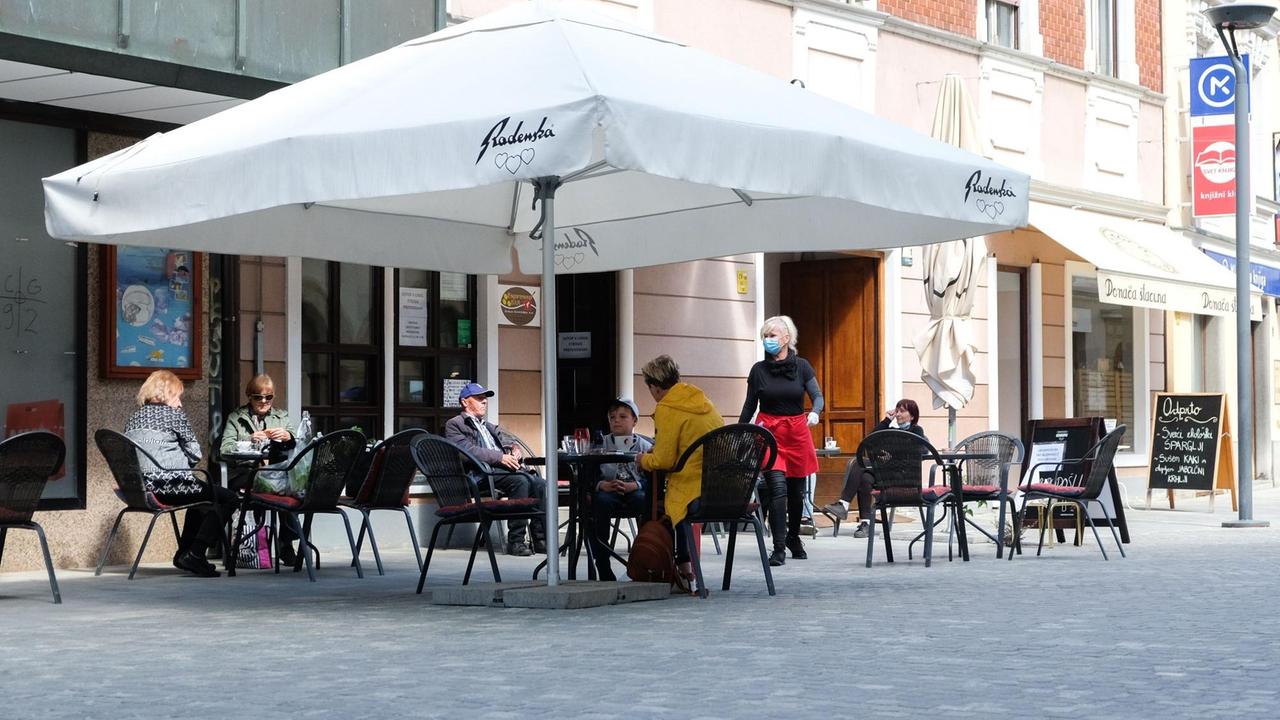 Gäste sitzen im Außenbereich eines Restaurants. Gäste sitzen im Außenbereich eines Restaurants.