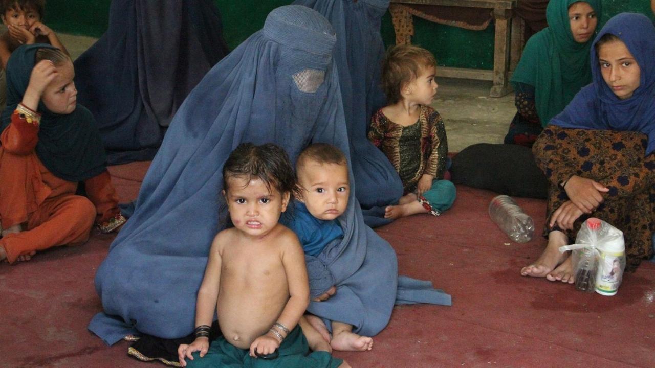 Afghanische Frauen mit ihren Kindern auf der Flucht Afghanische Frauen mit ihren Kindern auf der Flucht