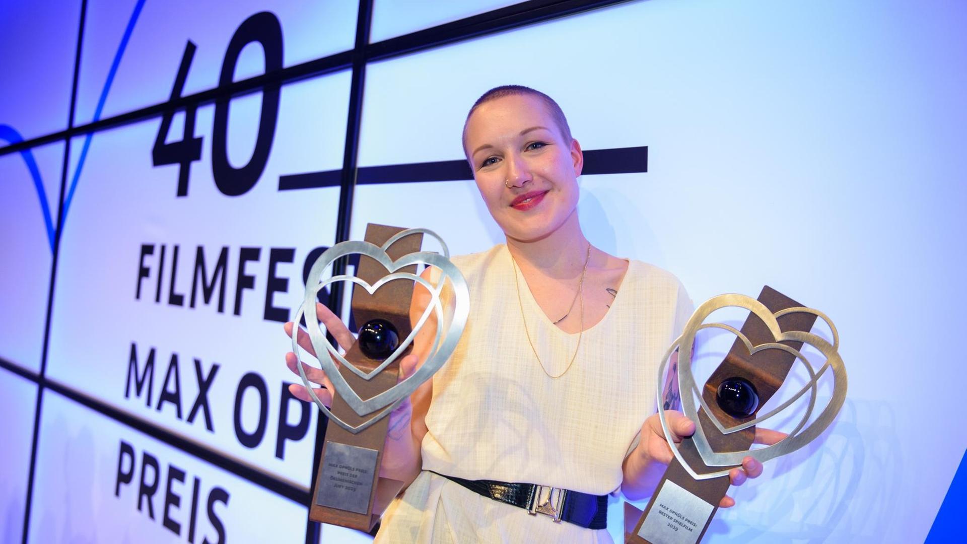 Regisseurin Susanne Heinrich hält nach der Preisverleihung des 40. Filmfestival Max Ophüls Preis ihre Trophäen für den Max Ophüls Preis Bester Spielfilm und Preis der ökumenischen Jury in der Hand, die sie für ihren Film "Das melancholische Mädchen" erhalten hat. Regisseurin Susanne Heinrich hält nach der Preisverleihung des 40. Filmfestival Max Ophüls Preis ihre Trophäen für den Max Ophüls Preis Bester Spielfilm und Preis der ökumenischen Jury in der Hand, die sie für ihren Film "Das melancholische Mädchen" erhalten hat.