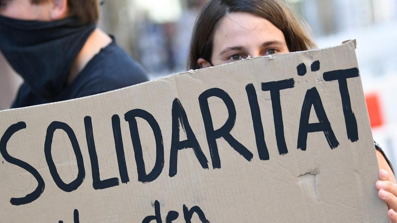 Eine Demonstrantin hält ein Plakat in der Hand. Eine Demonstrantin hält ein Plakat in der Hand.